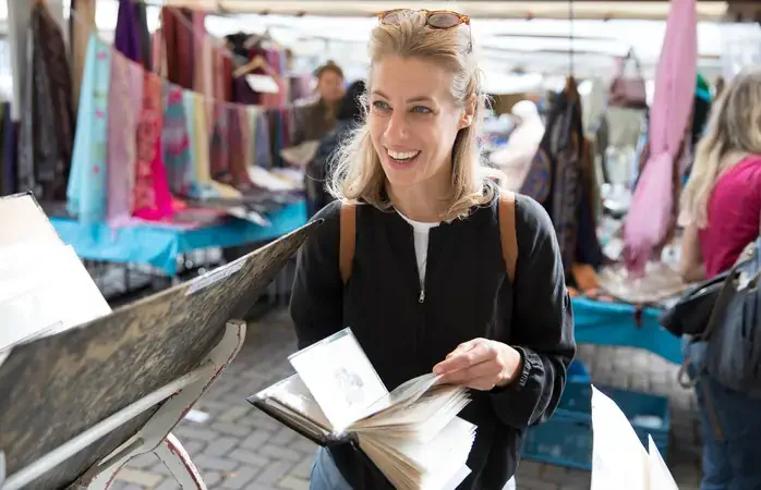 Girl looking at books in an antiques market.